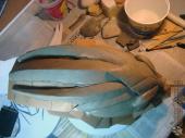 Adding cardboard around the base of the sculpture