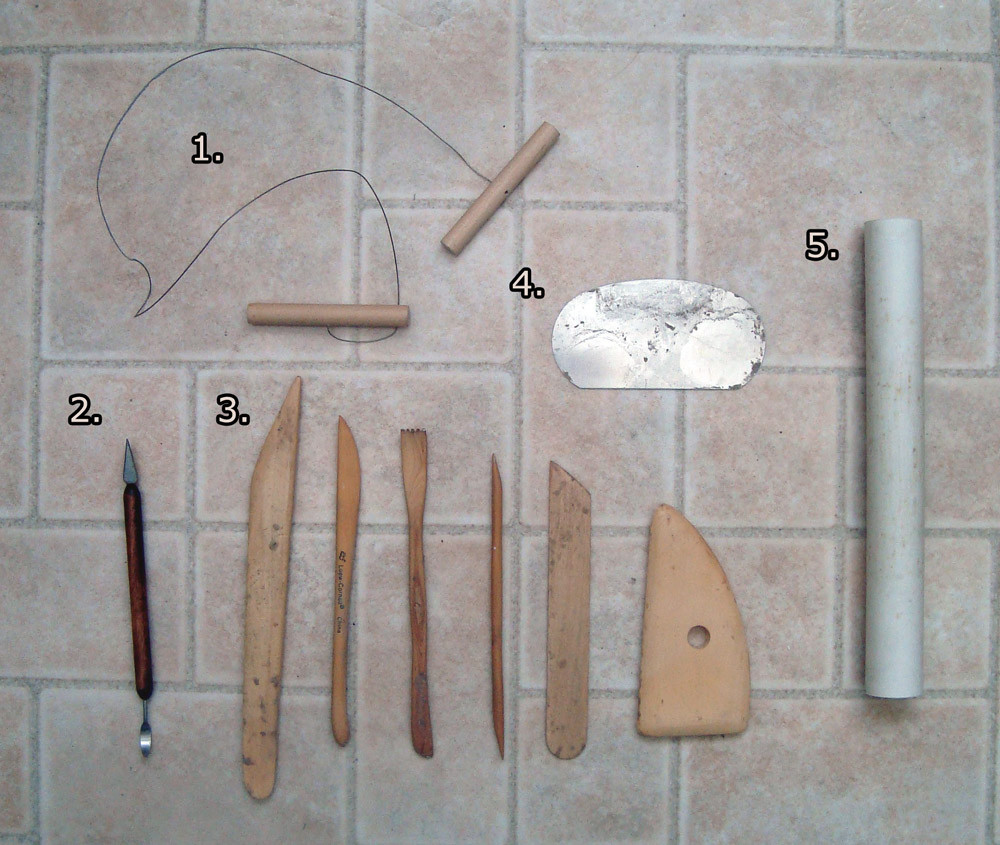 Various tools for sculpting - clay wire, sculpting knife, wooden tools, metal scraper, rolling pin