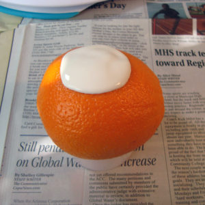 Wet, uncured latex on the surface of an orange