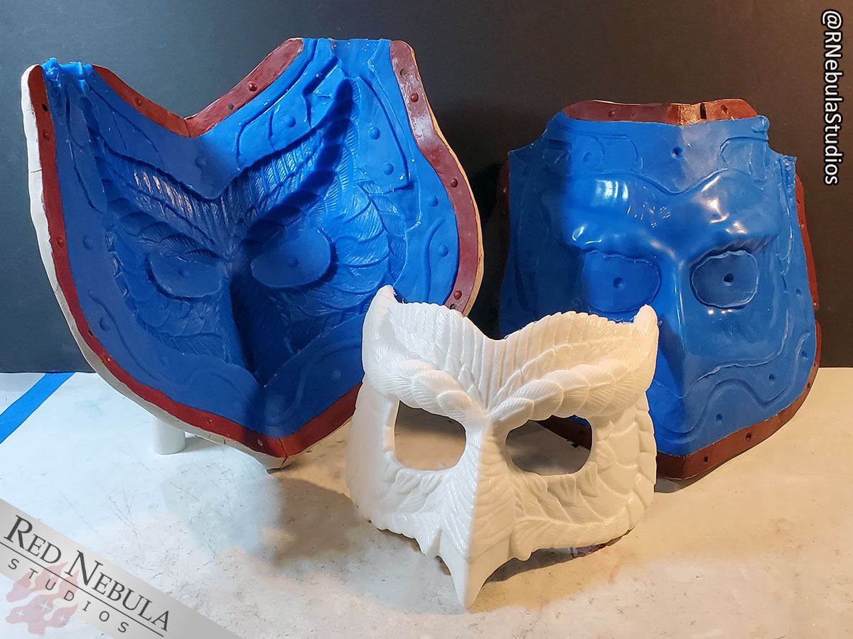 The open owl mask matrix mold in the background, with a finished white cast resin mask in front.