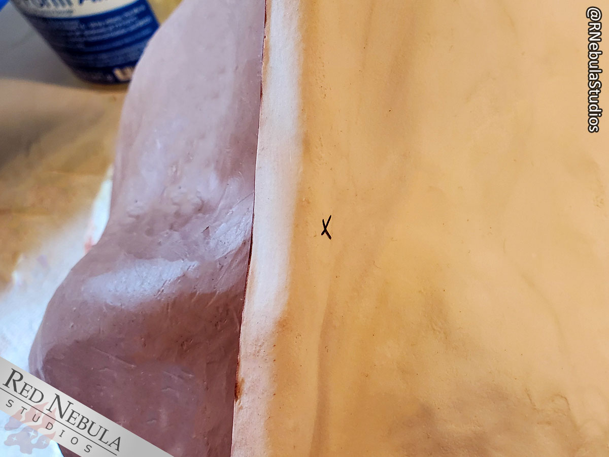 An X is marked in ink on the completed side of the mold showing the location of one of the mold keys.
